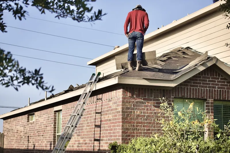Professional roofer working on a residential roof in West Morris